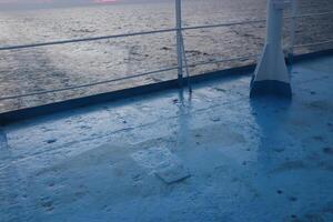 A boat deck with a railing and a railing photo