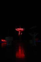 A red neon sign on a dark night photo