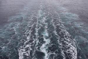 A view of the ocean from the back of a boat photo