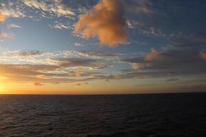 A sunset over the ocean from a cruise ship photo