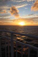 Sunset on the ocean from a cruise ship photo