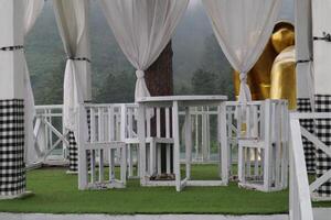 A white table with white curtains photo