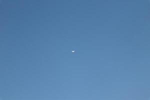 A small plane flying in the blue sky photo