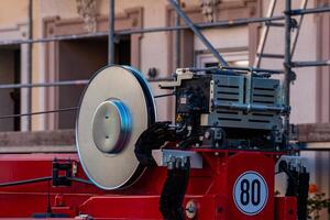 A construction rig is set up at a building site, featuring a large photo