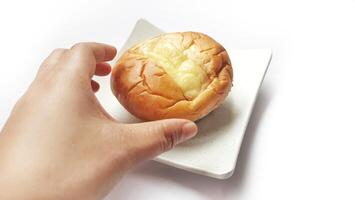 Hand holding double cheese bread on plate photo