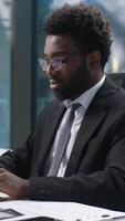 Confident happy African American man working typing computer pc manager office worker male looking at camera smiling businessman business employer entrepreneur online work guy nodding head programmer video