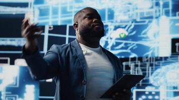 Black public speaker host presenting AI neural networks at live event, sharing insight on machine learning and predictive analytics. Young engineer presenter at tech convention. Camera B. video