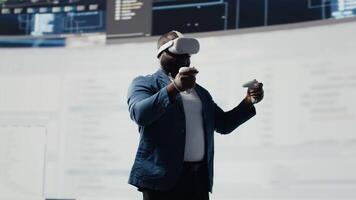 African American programmer engaging in virtual reality with a headset, focusing on system development. Utilizing code on terminal window to debug and design new software. IT career. Camera B. video