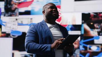 Young black person connecting to global social networks apps through mobile devices, opening platforms online on the dashboard. Communication and multitasking on social media. Camera B. video