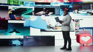 Joyful man using streaming services on laptop, receiving personalized recommendations. Upbeat user using notebook, enjoying access to wide variety of online clips, camera A video