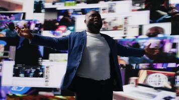 African american man connected to a global network through mobile devices, opening apps and streaming services platforms. Emphasizing communication and user interface evolution. Camera B. video