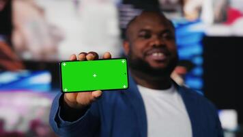 Black socials user shows a smartphone with isolated screen, digital system of networks and applications on dashboard. Highlighting the integration of AI and fintech. Multitasking. Camera B. video