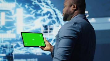 Modern black person in digital space uses isolated display with AI tools, representing artificial intelligence data structures and intelligent systems. Innovation and cybernetics for science. Camera B. video