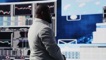 Modern business manager thinking about new successful ideas to increase his profit and develop the company, using insight and KPI projections or models for strategic decision making. Camera B. video