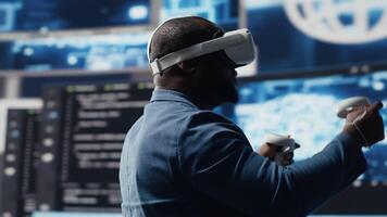 Digital tech expert coding and using VR headset at innovation hub, showcasing the intersection of data science and cybersecurity. Coding life immersed in high tech code development. Camera B. video