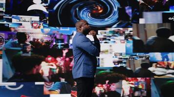 Smiling african american influencer being connected on vibrant digital interfaces and visualizations, representing mobile content creation, global reach and social network experiences. Camera A. video