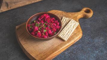 Healthy beetroot salad with herbs and beans served in a rustic bowl on a wooden cutting board with crispbread. Natural light and cozy kitchen atmosphere photo