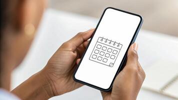 Flexible working. Person holding smartphone calendar app, planning schedule, remote work, hybrid, work from home ,remote ,work life balance photo