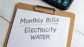 Tax finance budget, Financial accounting concepts. Monthly bills, electricity, water, clipboard, and calculator white desk . Payment, Debt, Penalty, Credit, Bill, Businessman, Office, Money photo