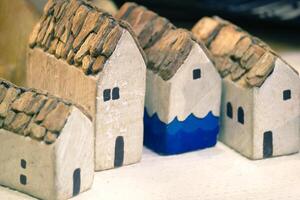 Miniature House On Top Table, Building Blocks Arranged In Row. photo