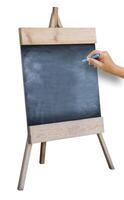 The Hand That Catches Chalk Is Preparing To Write the Alphabet On Wooden Sidewalk Sign With Blank Black Menu Board Isolated On White Background. photo