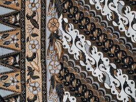 background pattern featuring motifs commonly found in Javanese batik. The pattern is symmetrical and abstract, and can be used on fabric, clothing, or wrapping paper designs. photo
