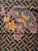 a black and purple fabric with a flower design photo
