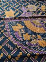 a purple and gold patterned fabric with a blue and yellow design photo