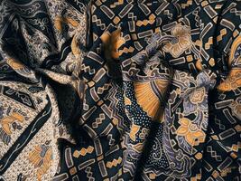 a black and yellow fabric with a pattern photo