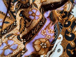 a background pattern featuring motifs commonly found in Javanese batik. The pattern is symmetrical and abstract, and can be used on fabric, clothing, or wrapping paper designs. photo