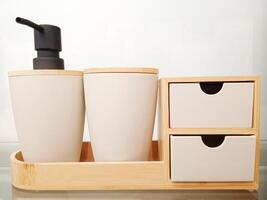 A bathroom set with two soap dispensers and two drawers photo
