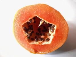 A papaya with seeds on the outside photo