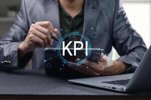 Businessman Analyzing Key Performance Indicators on Digital Device photo