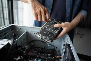 a Engineer installing Hardware holding a computer motherboard photo