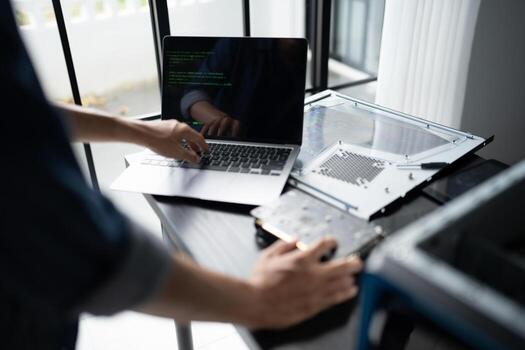 a Engineer installing Hardware working on a laptop computer photo