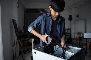 a Engineer installing Hardware fixing a computer in a room photo