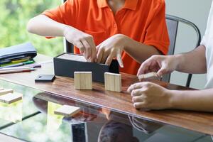 a man and a boy playing with wooden blocks. photo