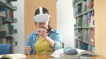 Young student using virtual reality headset in the library for explore the realistic data.. video