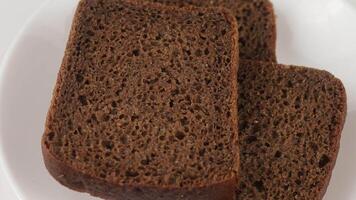 Two slices of dark chocolate bread on a white plate video