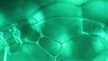 Green bubbles reflections on black background, liquid surface abstraction, colour waves, deep dark backgrounds, geometric water shapes, bubbles edges, illuminated shapes video