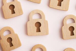 Wooden Padlock Shape, Light Background Symbolizing Security, Safety, and Privacy. photo