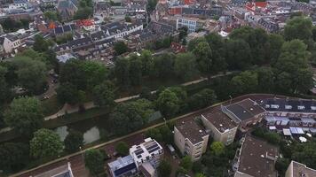 Aerial view of Utrecht, Netherlands, featuring the Dom Tower, traditional Dutch rooftops, tree lined streets, and a blend of urban and green spaces. video