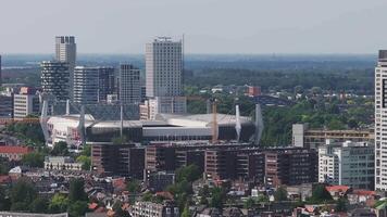 Aerial view of Eindhoven, Netherlands, with Philips Stadion, modern buildings, greenery, and construction cranes in a slow sweeping pan. video