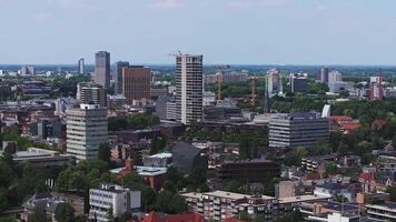 Aerial view of Eindhoven, Netherlands, featuring Philips Stadium, modern skyscrapers, traditional architecture, and lush greenery in the foreground. video