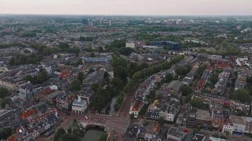 Aerial view of Utrecht, Netherlands, showing canals, traditional Dutch buildings, a blue structure, and greenery with a gradual panning motion. video
