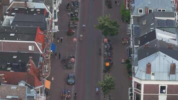 Aerial view of a street in Utrecht, Netherlands, showing Dutch buildings, a church like structure, vehicles, cyclists, and construction activity. video