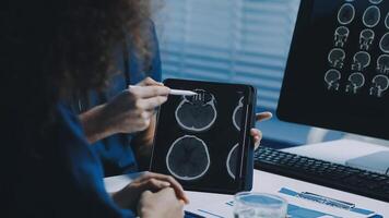 A woman is looking at an mri scan on a computer video