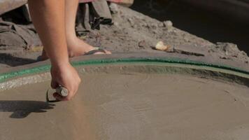 Crafting a smooth surface with hand tools at a construction site video