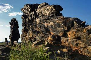 Teufelsmauer rock wall shadowed sandstone cliff under clear blue evening sky photo