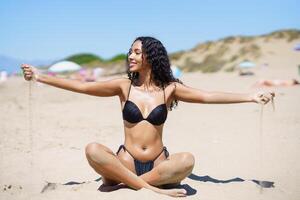 A Joyful Beach Moment A Woman Passionately Enjoying a Wonderful Day Under the Sun photo